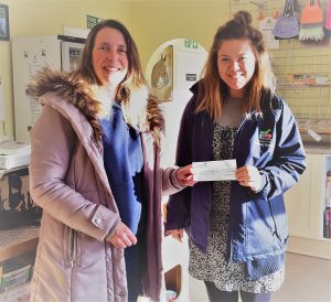 RMS' Sarah Benwell (L) presents a cheque for £110 to The Margaret Green Rescue Foundation in Church Knowle. 